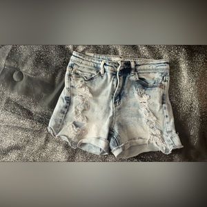 Blue ripped jean shorts.